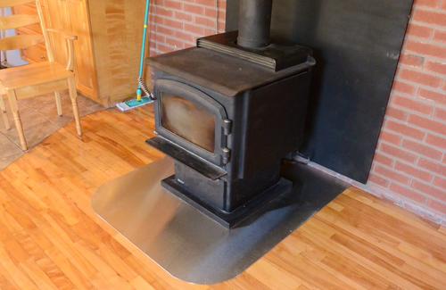 Wood stove hearth plate from stainless steel